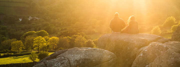 couple sitting on a rock on dartmoor