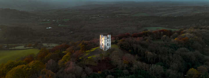 Haldon Belvedere (Lawrence Castle) in Haldon forest, Devon during golden hour with a stormy sky